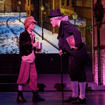 Scrooge talking to a boy asking for alms