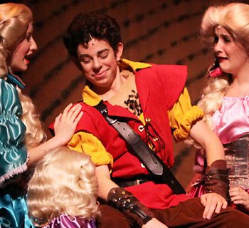 Gaston from Beauty and the Beast surrounded by girls
