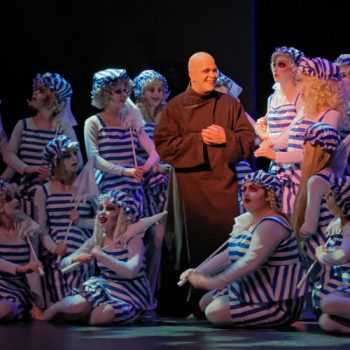 Fester Addams and ensemble of the El Dorado Musical Theatre production of the Addams Family