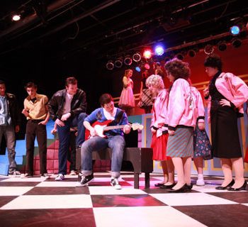 Boys and girls from the Grease Musical