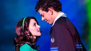 Two actors gazing intimately on stage