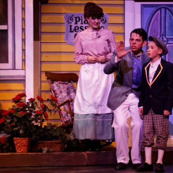 A man, woman, and a child from the Music Man