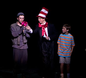 Cat in a Hat handing an item to a young man