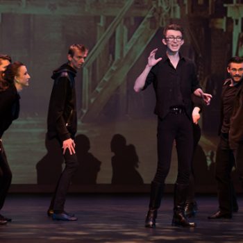Theater youth wearing black while performing