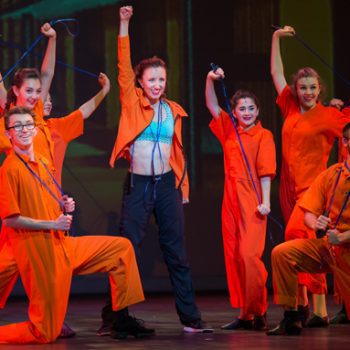 Theater youth wearing orange jumpsuits