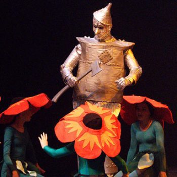 Tin Man in Emerald City surrounded by flowers