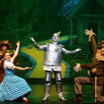 Dorothy, the Scarecrow, and the Lion showing off the Tin Man
