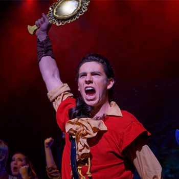 Gaston holding a mirror in front of a mob