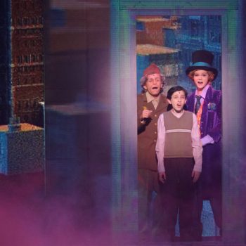 Willy Wonka, Charlie, and Grandpa in the glass elevator
