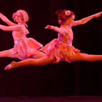 Two ballet dancers leaping
