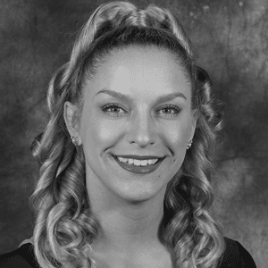 A black and white photo of a woman smiling.