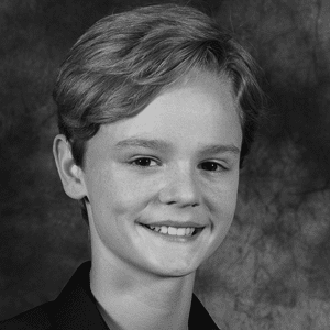 A black and white photo of a young man.