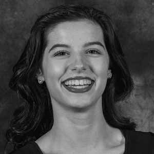 A black and white photo of a young woman smiling.