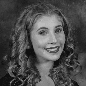 A black and white photo of a woman with curly hair.