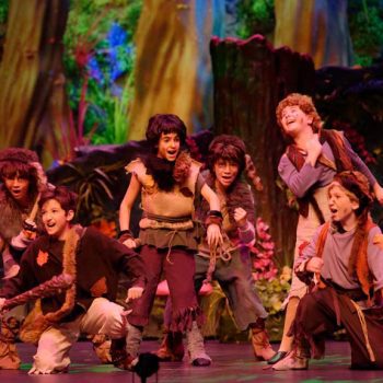 The lost boys from the Peter Pan musical dancing