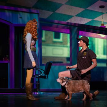 Woman, delivery person, bulldog, stage scene.
