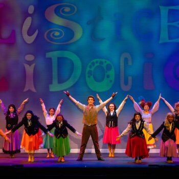 Colorful stage musical ensemble with raised arms