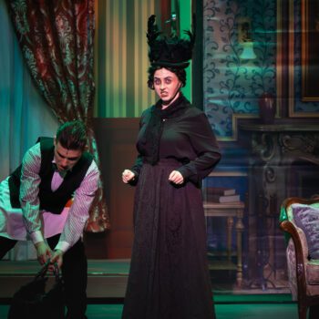 Actors performing Victorian-era drama on stage