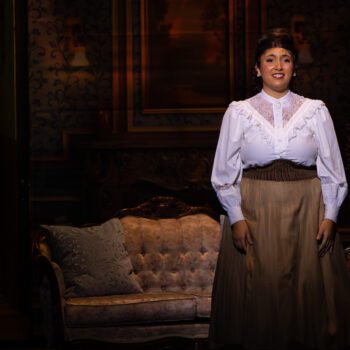 Solo performer in Victorian costume on stage