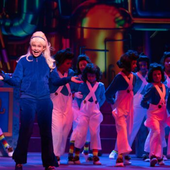 Theatrical lead with child dancers onstage