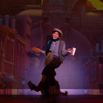 Performer dancing on theatrical city street stage