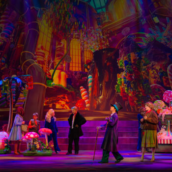 Vibrant candyland stage production with performers