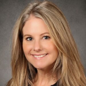 Smiling blonde woman headshot on gray background