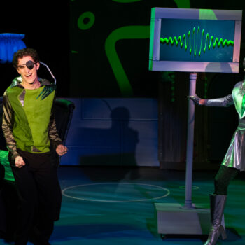 Actors in green and silver sci-fi costumes