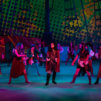 Actors in pirate costumes dancing on stage