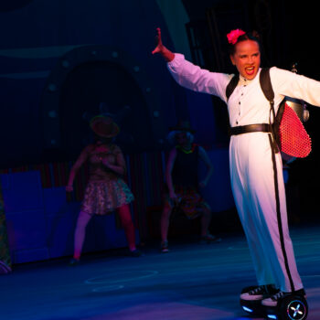 Performer in white costume on hoverboard