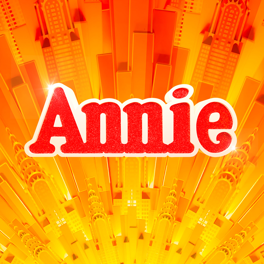 Glittery red Annie logo on orange background
